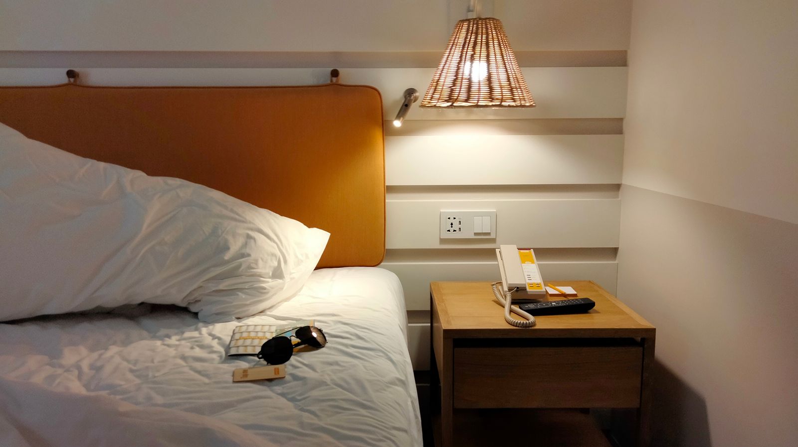 A warm bedside lamp lighting a bedroom after dark